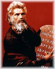 Moses brings the ten commandments in two stone tablets.