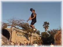 Unicyclist catches his hat.